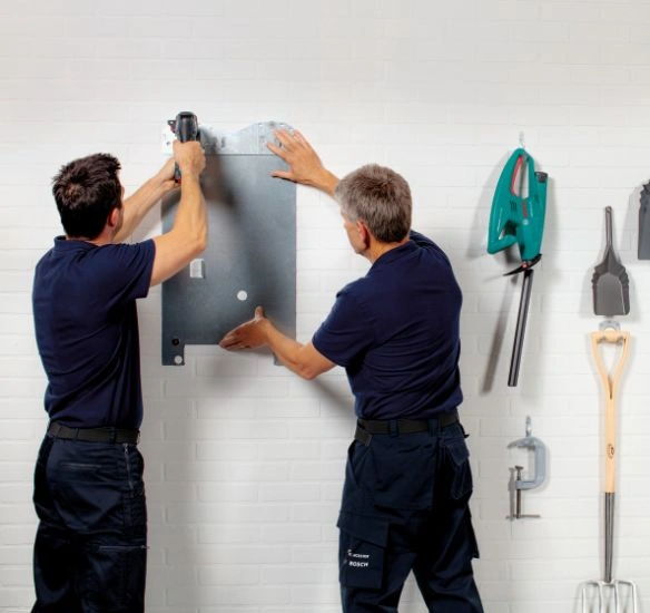 Installers installing a jig on the wall